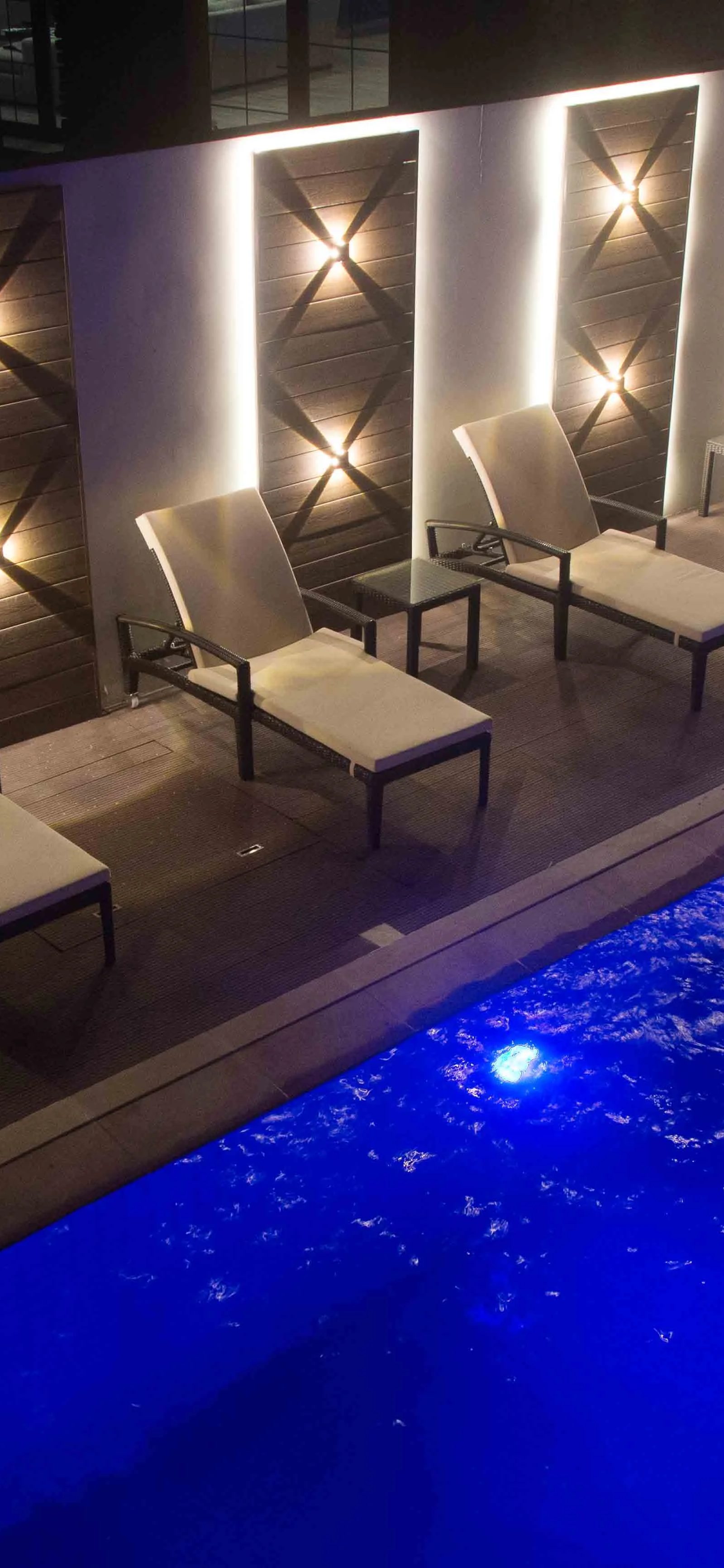 Loungers by blue water by Jorge Rangel Interiors, design — industrial