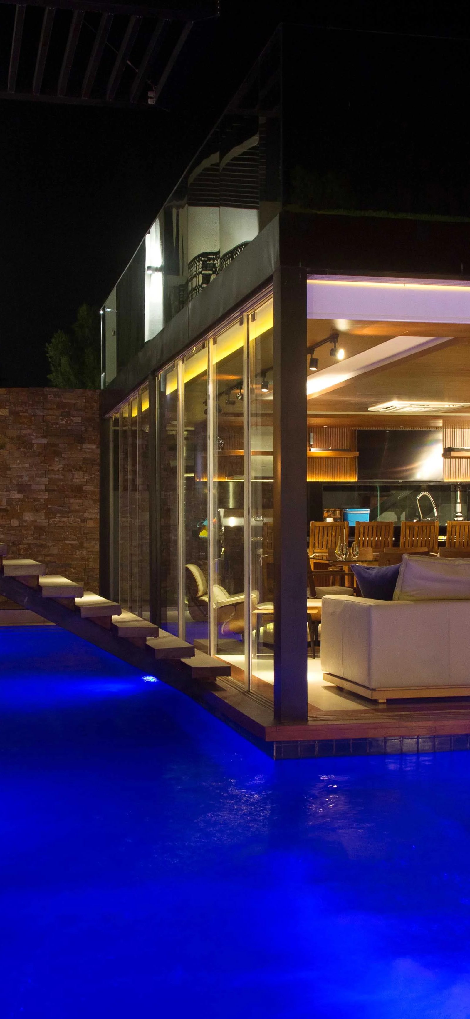 Blue pool, warm windows by Jorge Rangel Interiors, design — industrial